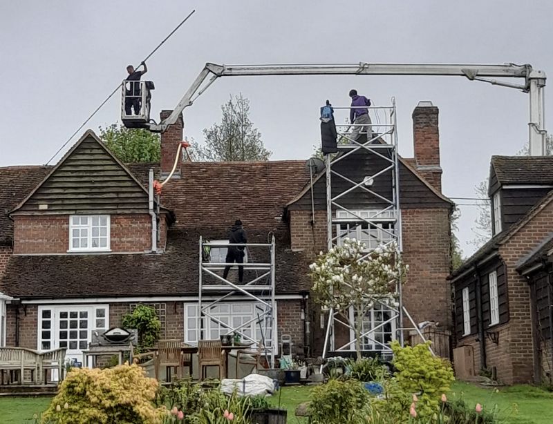 The Moss Cleaners using cherry picker and scaffolding to clean roof safely and professionally in Devizes, Wiltshire